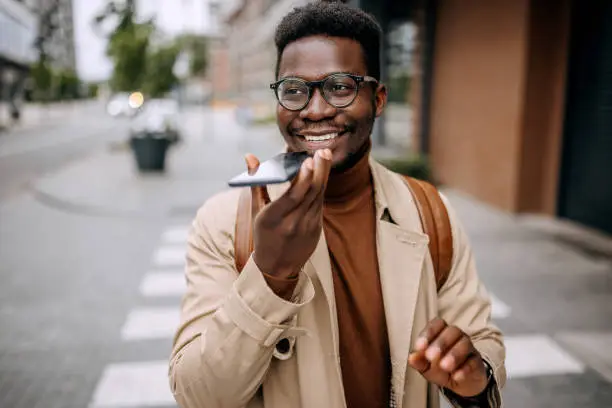 Photo of Portrait of handsome businessman sending voice message