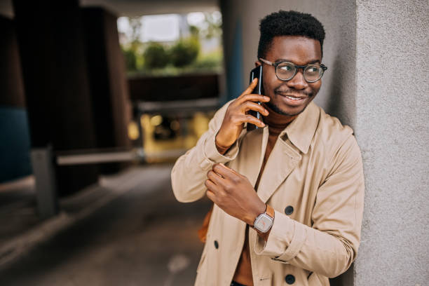 istock Young handsome man having a phone call leaning on the wall outdoors 1343776112