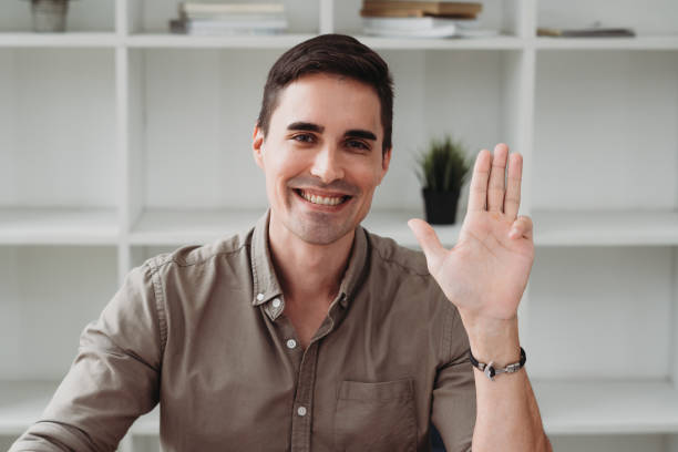 istock Smiling young guy taking selfie photo on smartphone on the office, Caucasian man using digital device. Selfie photo concept. 1343777935