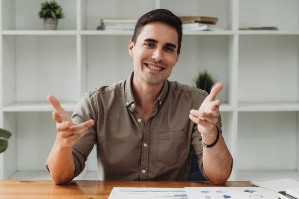 istock Smiling young guy taking selfie photo on smartphone on the office, Caucasian man using digital device. Selfie photo concept. 1343777951