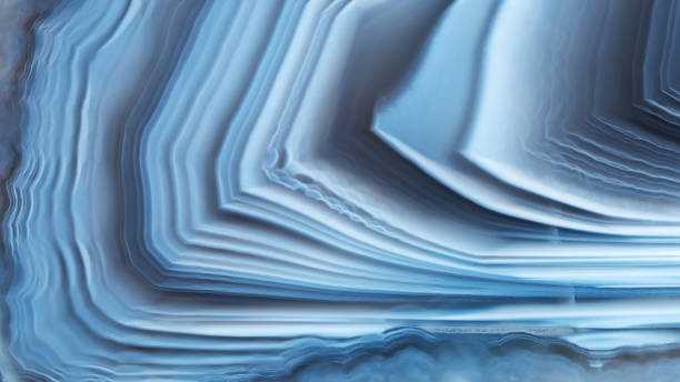 istock The texture of concentrically layered white-blue agate, panoramic. 1343779695