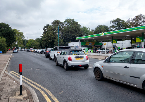 Long tailbacks of cars queuing on both sides of a main road near a BP filling station during a petrol shortage in the UK.