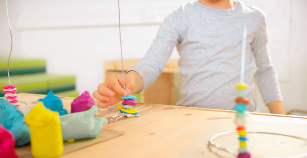 istock Boy making spine model out of plasticine 1343788149