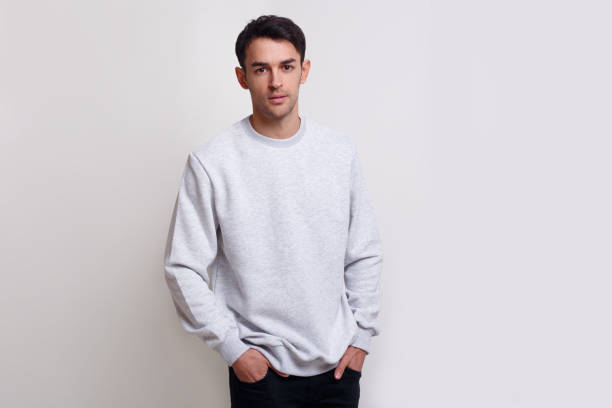 istock Attractive young man in grey jumper and jeans, isolated white background. Horizontal view. 1343790878