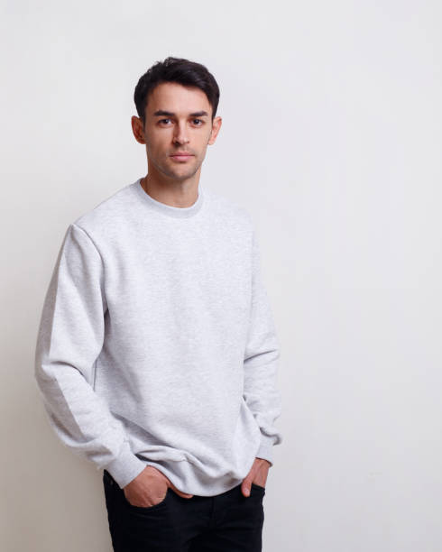 istock Attractive young man in grey jumper and jeans, isolated white background. 1343790880