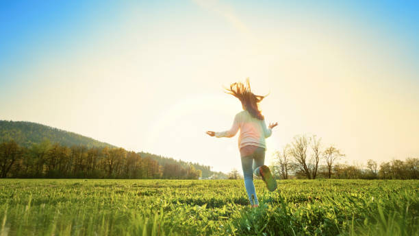 istock Girl running in a sunny meadow 1343791171