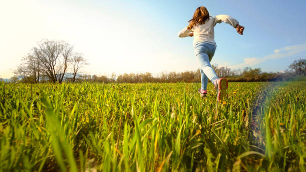 istock Girl running on a sunny meadow 1343791202