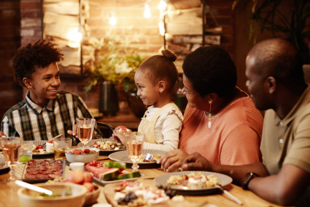 istock African American Family at Dinner Table Together 1343793433