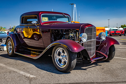 An old classic car sitting in the street