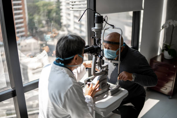 istock Optometrist examining patient's eyes - wearing face mask 1343801907