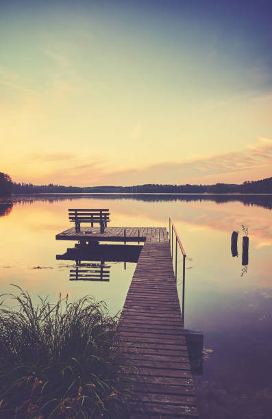 istock Lake with wooden pier at sunset. 1343805138