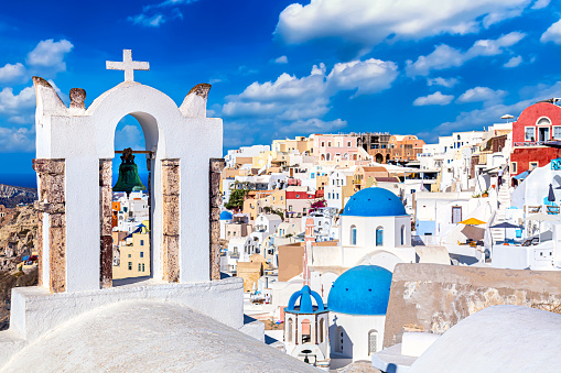 Oia village with famous white houses and blue churches on Santorini island, Aegean sea, Greece