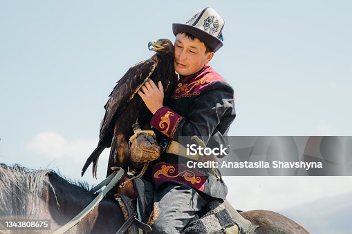istock Eagle Hunter in traditional costume with Eagle in the mountains of Central Asia 1343808675