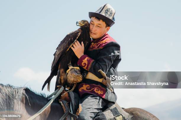 Eagle Hunter In Traditional Costume With Eagle In The Mountains Of Central Asia Stock Photo - Download Image Now