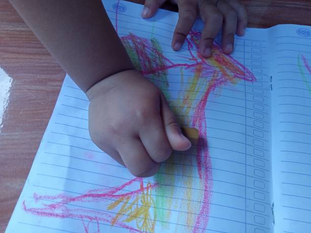 istock child's hand is painting 1343809181