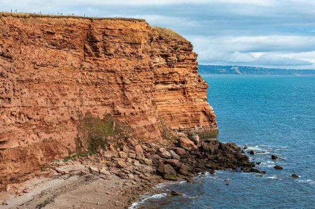 istock Red Otter Sandstone cliffs at Danger Point, walking east from Otterton Ledge, Devon 1343809211