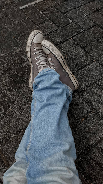 istock Close-Up Legs with jeans and casual shoes 1343809526
