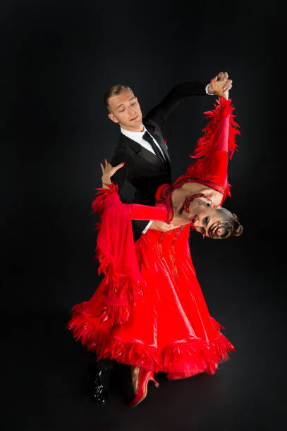 istock ballrom dance couple in a dance pose isolated on black background 1343809609