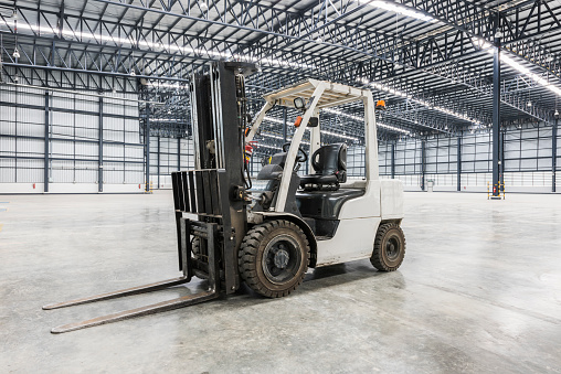 forklift in a modern warehouse in logistics area