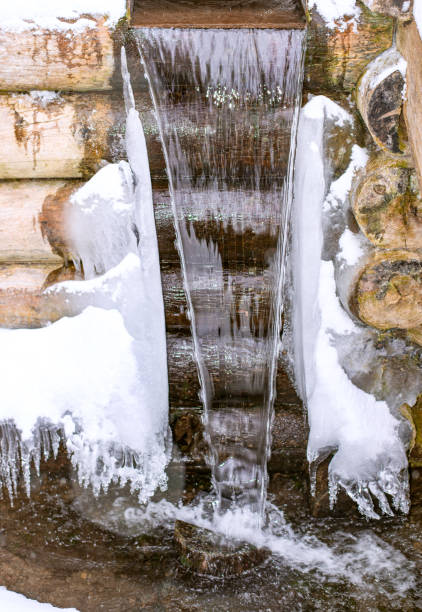 istock Waterfall of mountain spring cool water with icicles. 1343815278