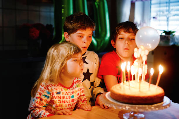Adorable kid boy celebrating tenth birthday. little toddler girl, sister child and two kids boys brothers blowing together candles on cake. Happy healthy family portrait with three children siblings Adorable kid boy celebrating tenth birthday. little toddler girl, sister child and two kids boys brothers blowing together candles on cake. Happy healthy family portrait with three children siblings. birthday wishes for daughter stock pictures, royalty-free photos & images