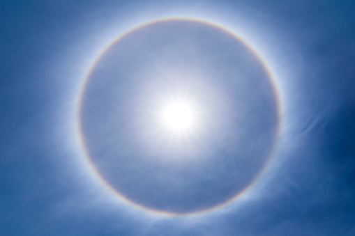 The sun shines brightly in the sky and natural phenomenon called circumscribed halo