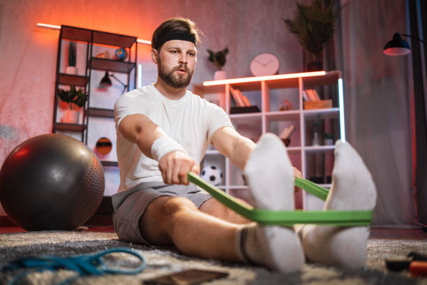istock Bearded man having evening workout with rubber band 1343822341