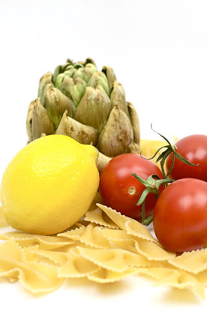 Artichoke, Lemon, Pasta, and Tomatoes stock photo