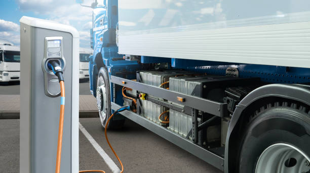 Electric truck with charging station Electric truck batteries are charged from the charging station. Concept electric vehicle stock pictures, royalty-free photos & images