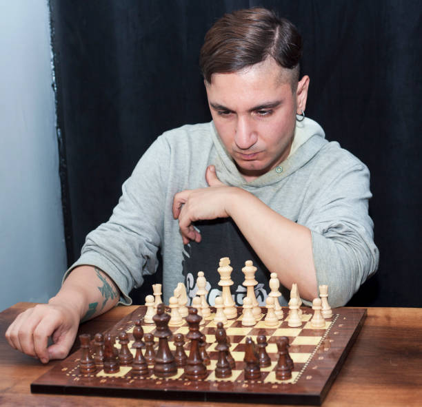 istock Young man looking at chessboard and thinking about next move 1343828838