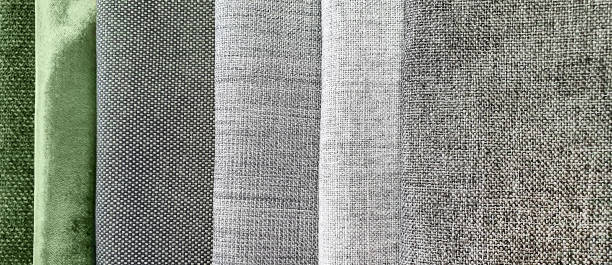 istock close up drapery samples in grey and green tone for interior curtain works. background of multicolored linen fabric texture use as banner, template. vertical samples of natural fabrics. 1343836713