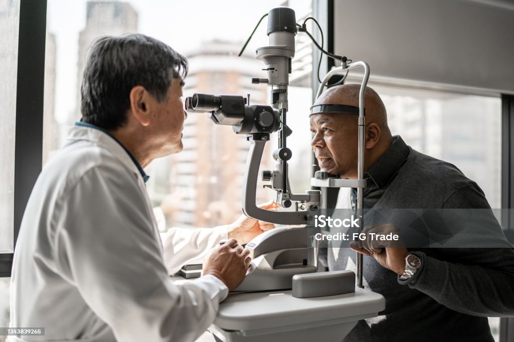 Ophthalmologist examining patient's eyes Eye Exam Stock Photo