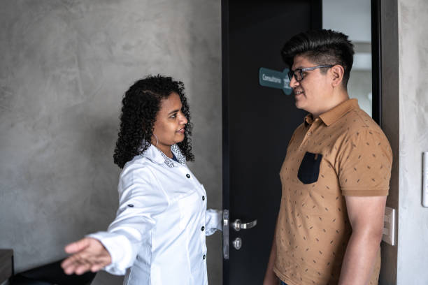 Doctor opening door and greeting patient