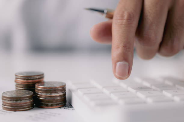 istock Accounting concept, Male hand push calculator is lying on desk in home office setting. Calculation of family expenses social income population 1343840418