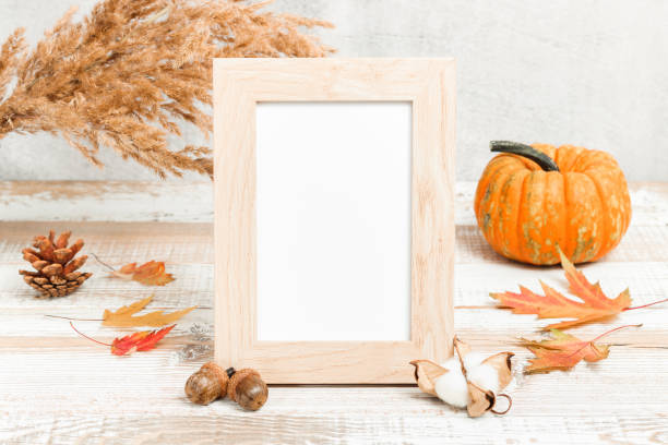 istock Blank photo frame with pumpkin and autumn decorations 1343840475