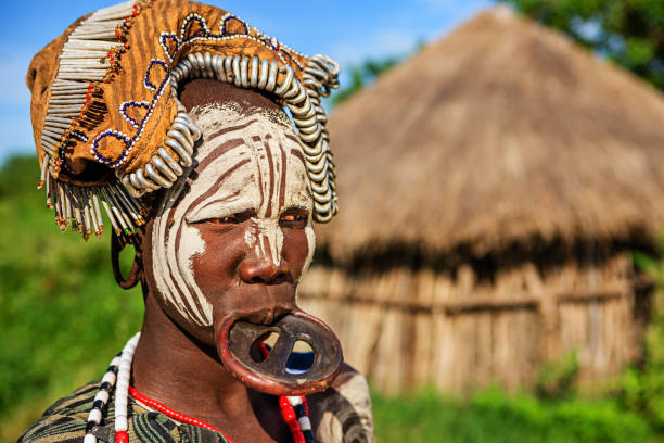 Portrait of woman from Mursi tribe, Ethiopia, Africa Mursi tribe are probably the last groups in Africa amongst whom it is still the norm for women to wear large pottery or wooden discs or ‘plates’ in their lower lips. ethiopia photos stock pictures, royalty-free photos & images
