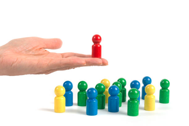 istock Game characters concepts - Hand presents a selected figure of a group 1343842478