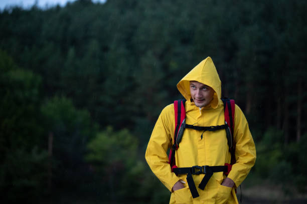 istock Hiker wearing a raincoat in a forest 1343849790
