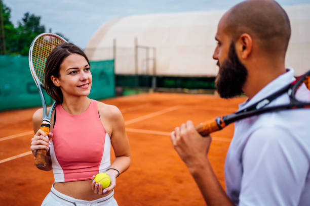 istock Tennis players talking after ending the game 1343850925