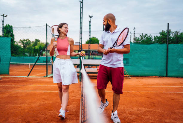 istock Tennis players talking after ending the game 1343851041