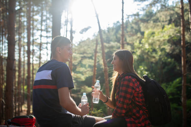 istock Resting and drinking water after hiking 1343851253