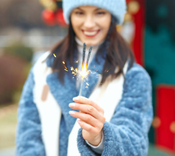 istock positive lady enjoying holidays with sparklers 1343851287