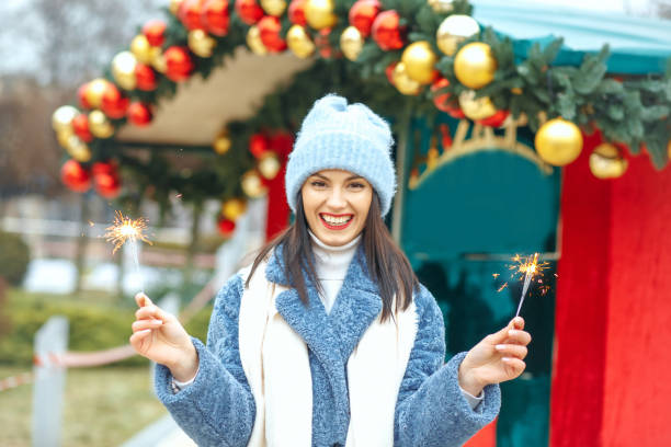 istock Elegant lady enjoying holidays with sparklers 1343851290