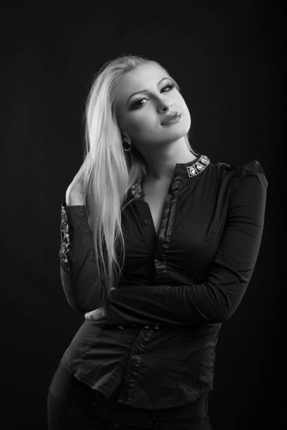 attractive blond lady with perfect makeup and long straight hair wears blouse, posing at studio. black and white sho - studio sho imagens e fotografias de stock