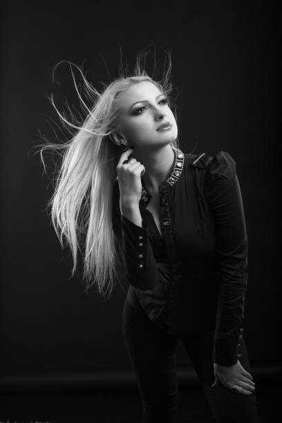 istock Romantic blond woman with long fluttering hair posing at studio 1343851425
