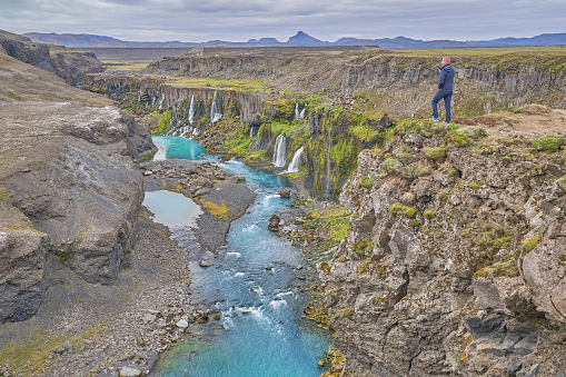 Hiker Enjoying the View of Sigöldugljufur Canyon and waterfalls in the beautiful and unique island nation of Iceland in Europe.