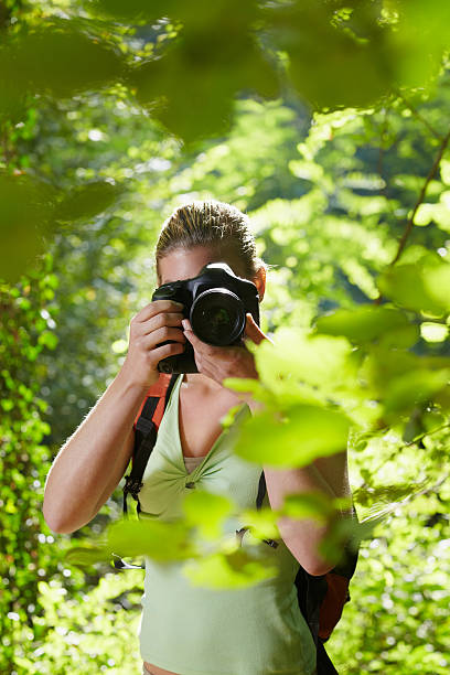 istock young female photographer hiking in forest 134385342