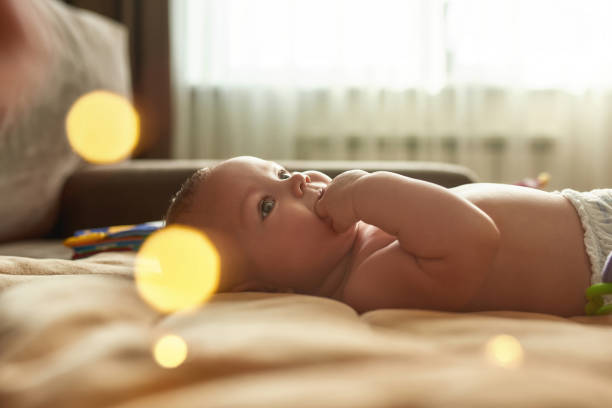 istock Pretty infant child calming itself by sucking fingers 1343863681