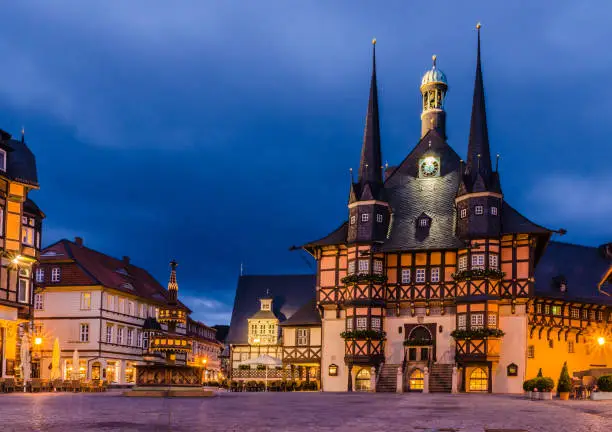 View of the market square in Wernigerode with the historic town hall and the benefactor fountain at the Blue Hour in the evening