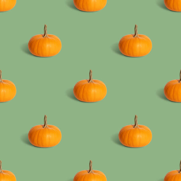 istock Pumpkin seamless pattern on a green background. Autumn or halloween concept. 1343866227